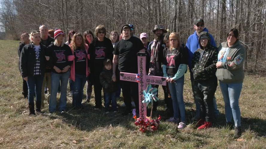 SERENITY MCKINNEY FAMILY GATHERS AROUND CROSS