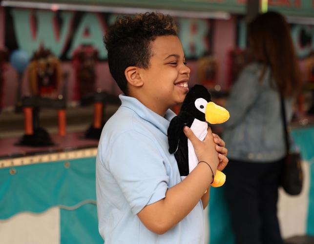 Child celebrates after winning prize at Chow Wagon