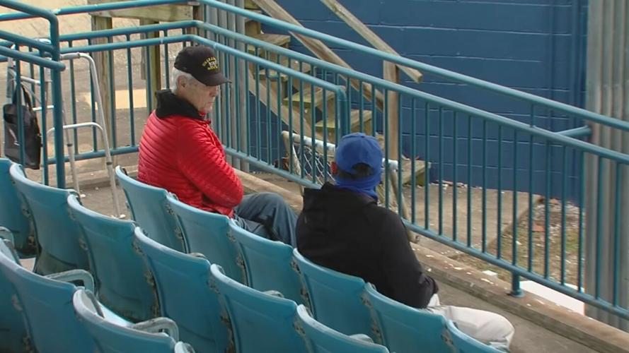 Men sit at seats formerly used at Fulton County Stadium.jpeg