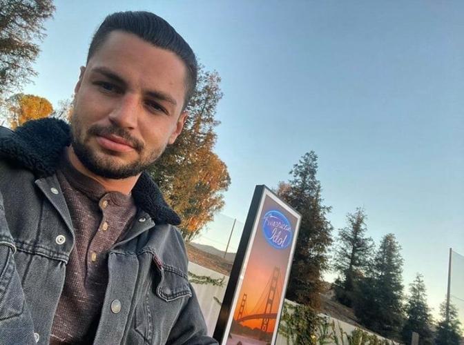 Chayce Beckham near American Idol signage