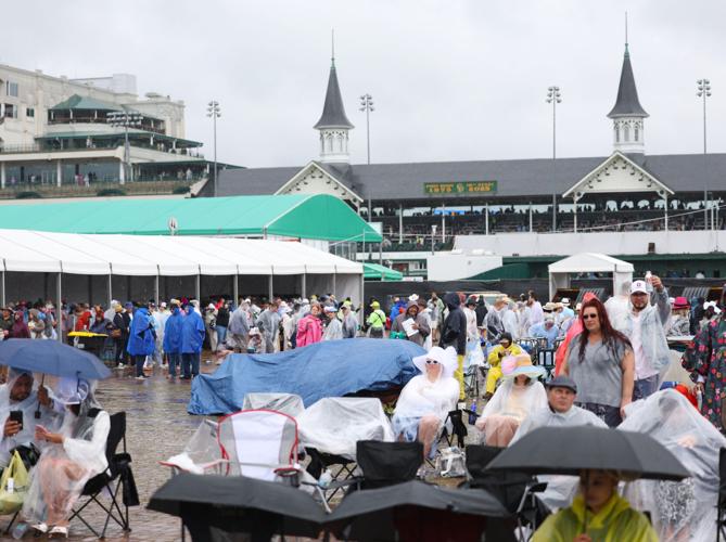 Crowd sits in rain infield.JPG