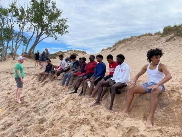 Basketball players on Michigan beach on KCARE trip