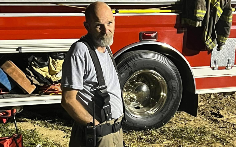 Raywick Fire Department Lt. Brian Hatt stands near a firetruck