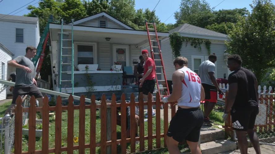 University of Louisville football players help repair a home in the Portland neighborhood
