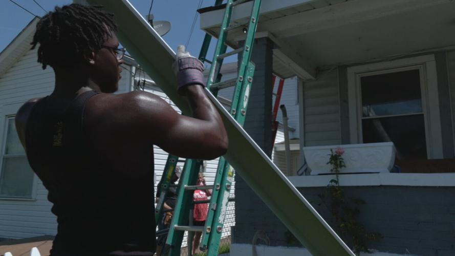 University of Louisville football players help repair a home in the Portland neighborhood