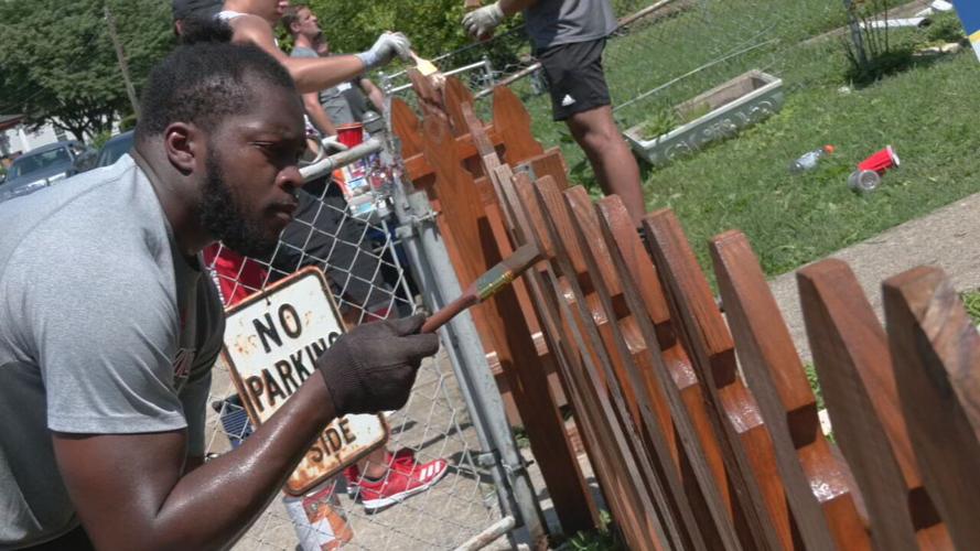 University of Louisville football players help repair a home in the Portland neighborhood