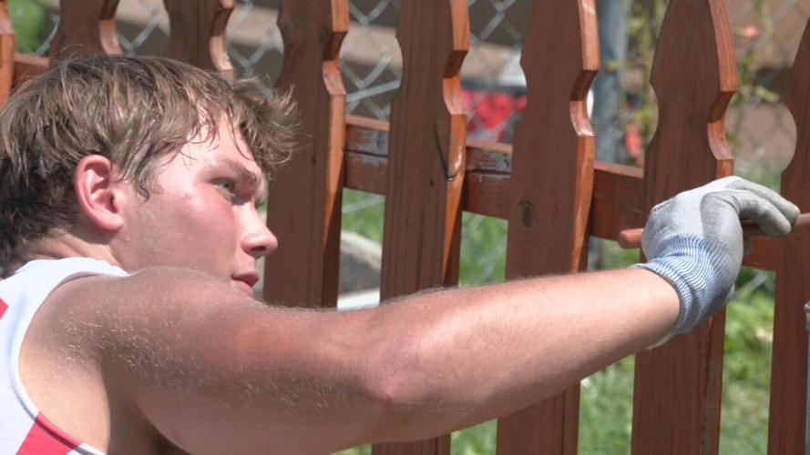 University of Louisville football players help repair a home in the Portland neighborhood