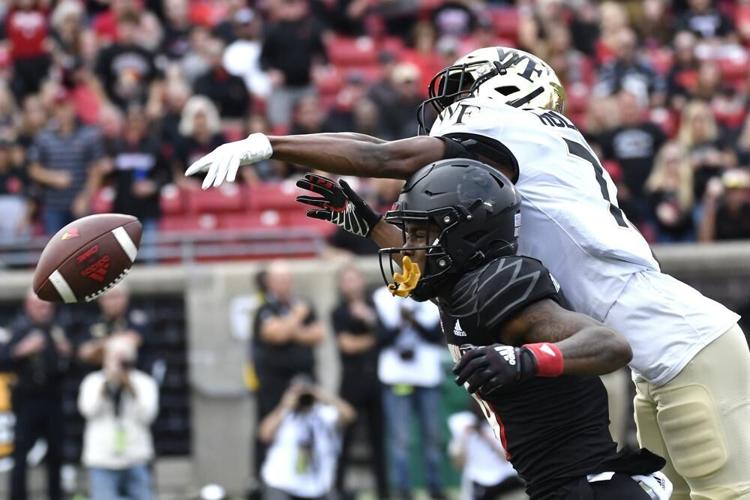 Wake Forest defensive back Gavin Holmes tips the ball away from Louisville wide receiver Ahmari Huggins Bruce.jpeg