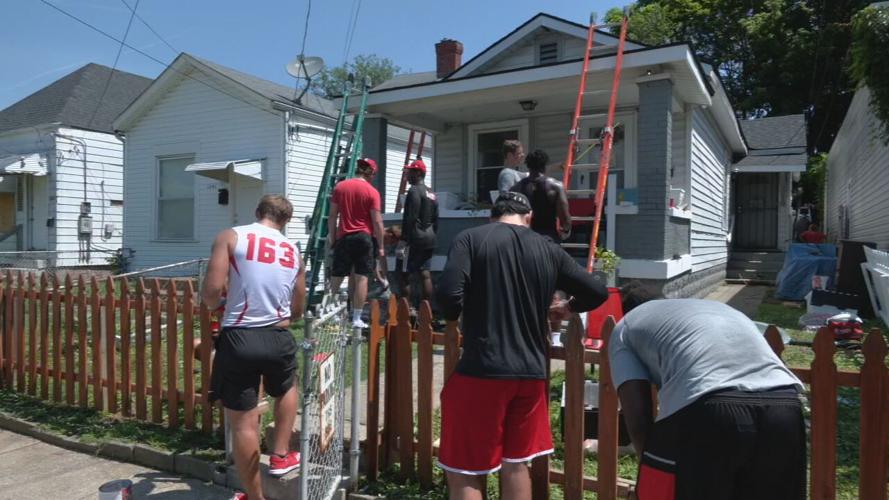 University of Louisville football players help repair a home in the Portland neighborhood