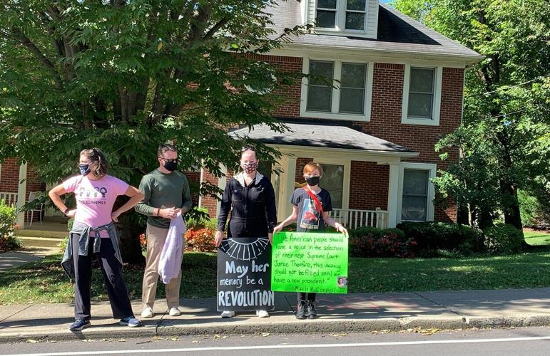 Protesters outside Mitch McConnell's home with signs