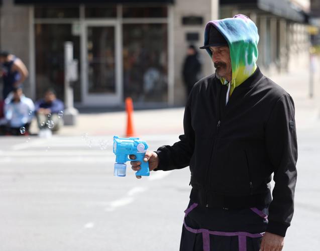 Vendor shoots blubbles from toy.JPG