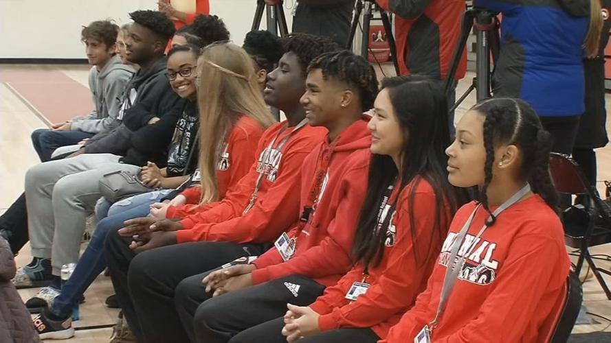 Audience members watch as Manual HS's Class of '76 unveils donation for Sports and Learning Complex
