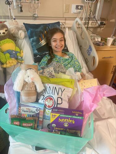 Alexis Bibb in hospital bed with gifts and cards
