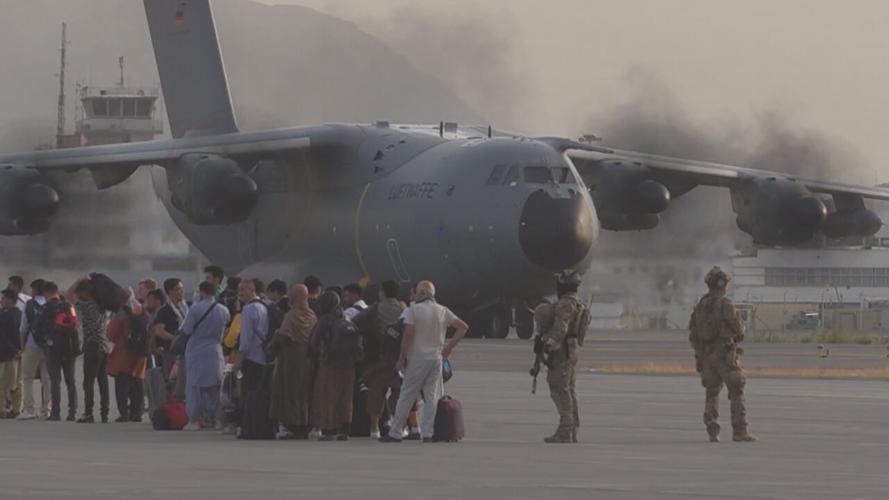 Afghan refugees in front of a US military aircraft in Kabul, Afghanistan