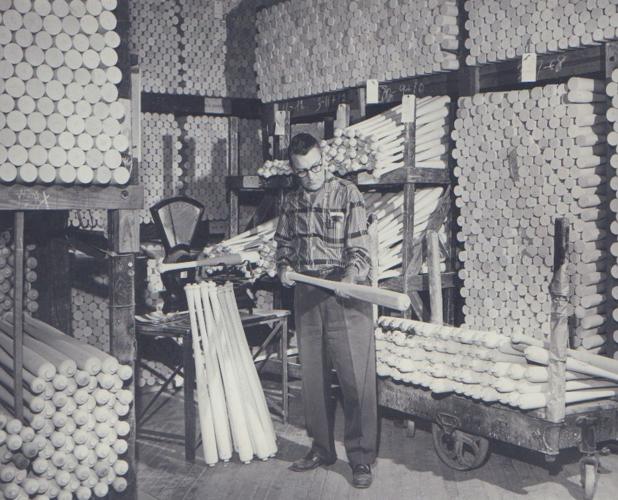 Unidentified Hillerich & Bradsby Co. employee inspecting baseball bats