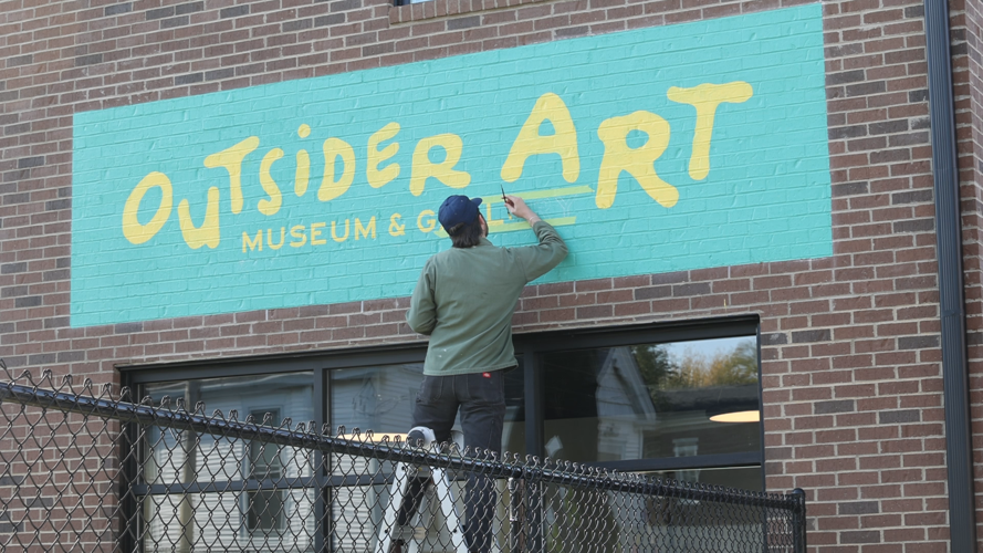 Painting logo outside of building.PNG