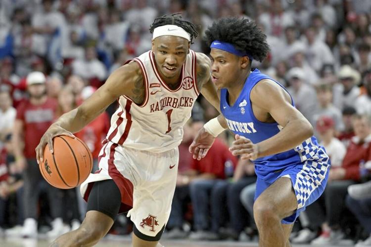 Arkansas guard JD Notae drives past Kentucky guard Sahvir Wheeler during the first half.jpeg
