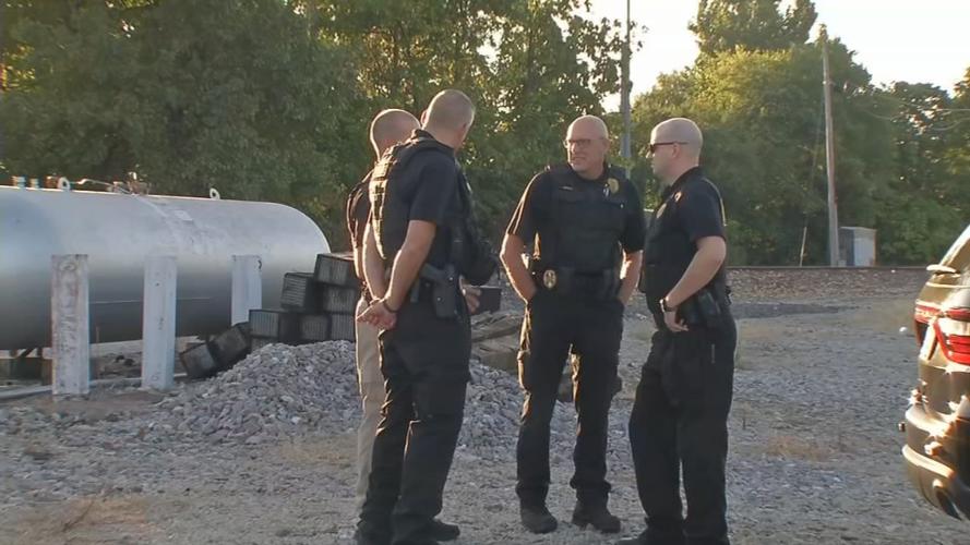 Norfolk Southern officials near railroad tracks
