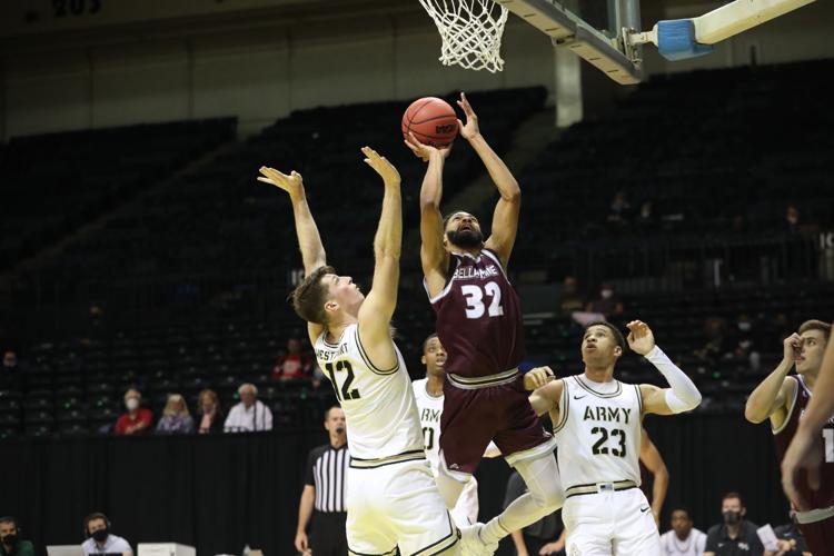 Bellarmine's Pedro Bradshaw, center, shoots a basket against Army defenders