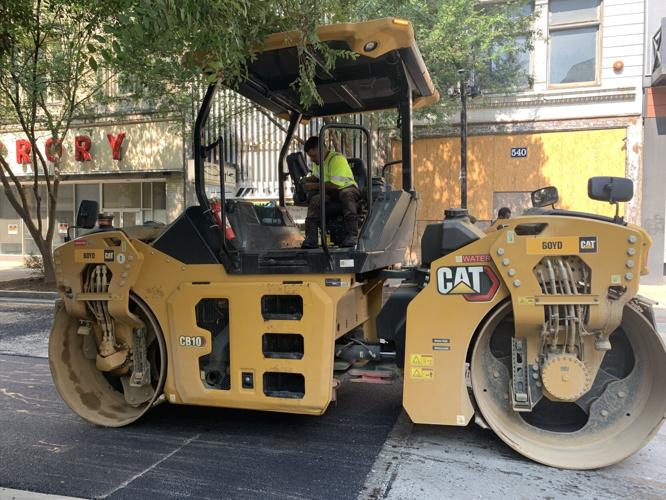 Louisville Metro Public Works crews pave a downtown Louisville road on July 26, 2023
