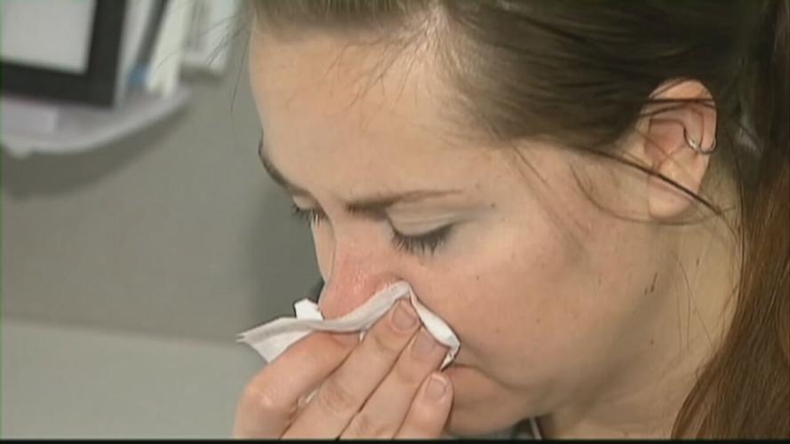 Woman blowing her nose.
