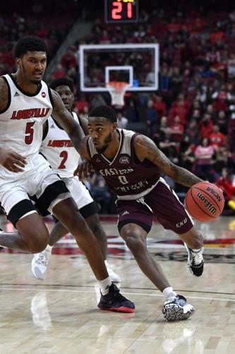 Eastern Kentucky guard Russhard Cruickshank (0) tries to drive past the defense of Louisville forward Malik Williams