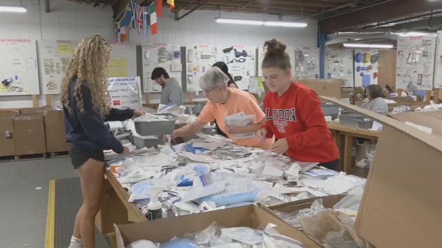 Volunteers for Louisville-based SOS pack medical supplies for JCPS students