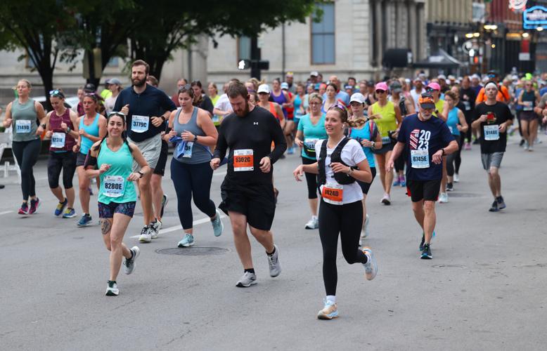 Marathon runners go by YUM center.JPG