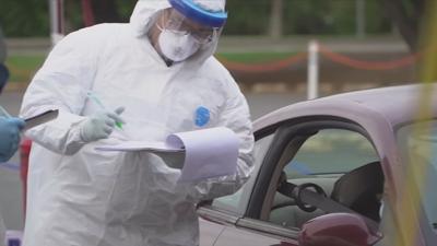 Medical worker at drive-thru COVID test site