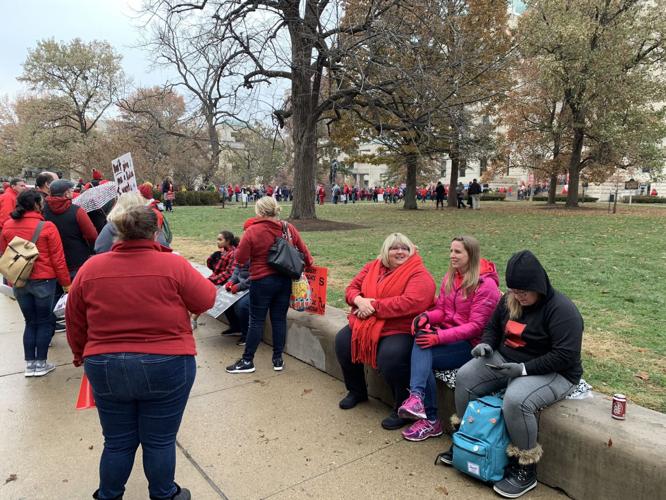 GO RED FOR ED - Teachers seated outside capitol.jpg