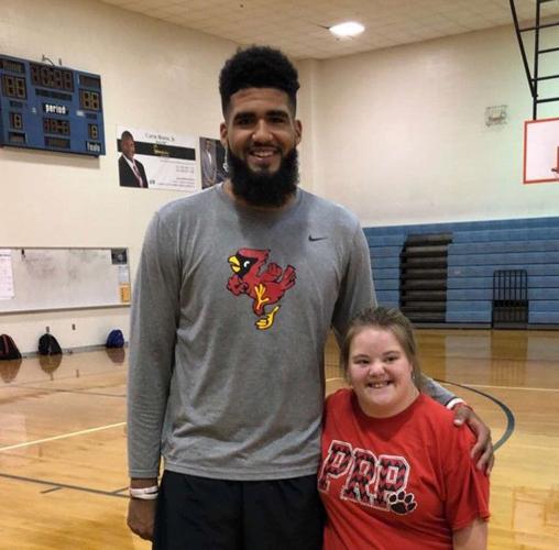 Trey Moses poses for a picture with a young fan