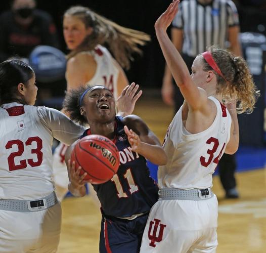 Belmont guard Destinee Wells (11) drives between Indiana guard Tori Campbell (23) and guard Grace Berger