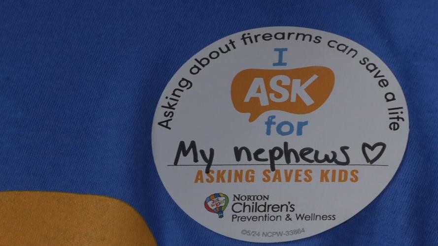 Alex Passamonte with Norton Children's Hospital wears a sticker raising awareness about ASK Day, saying she's asking for her nephews