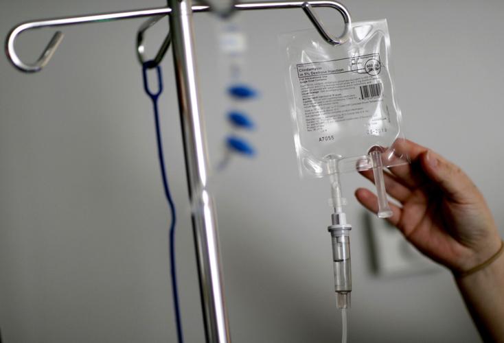 A nurse hooks up an IV to a  patient - medical - hospital file generic