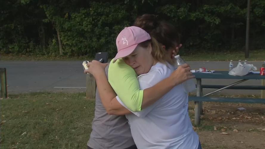 Searchers embrace while looking for missing mom Andrea Knabel in Iroquois Park area Sept. 11, 2019