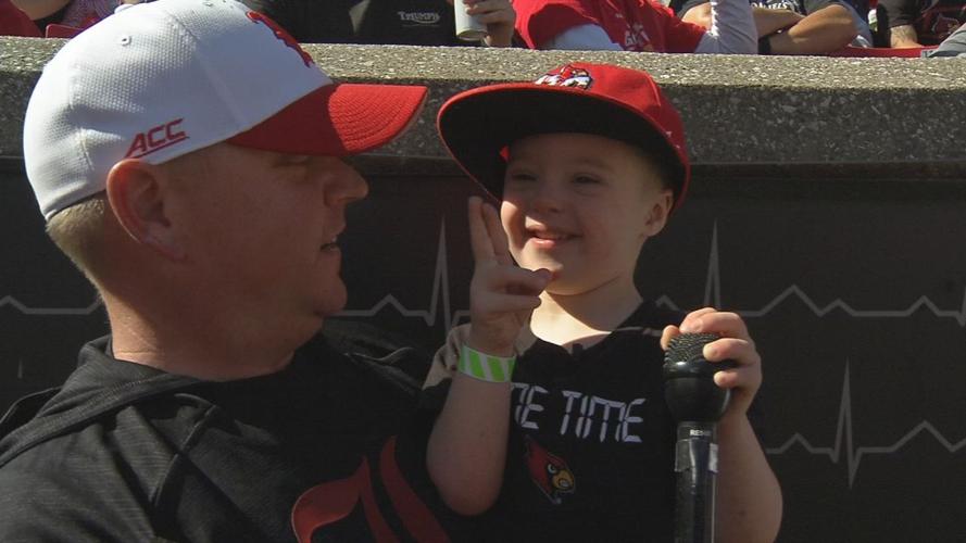 4-year-old boy with Down syndrome leads Cardinal Marching Band during halftime performance