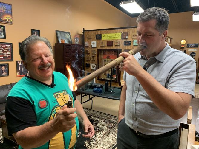 Keith gets a light for a massive cigar