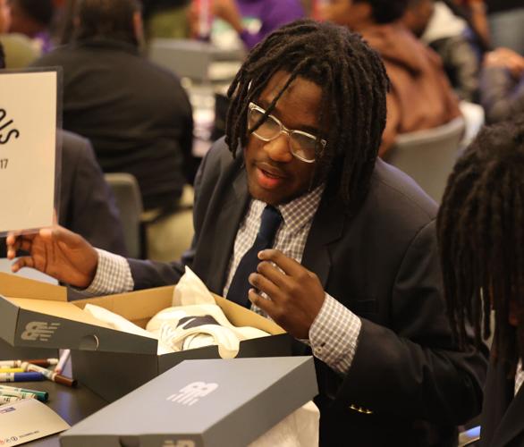 Boy looks at New Balance shoes.JPG