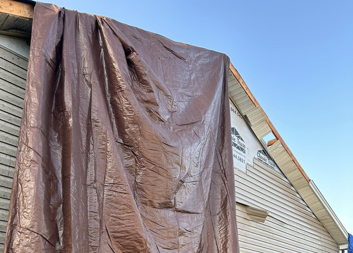 Tarp on a roof in southern Indiana after tornado touchdown on May 7, 2024