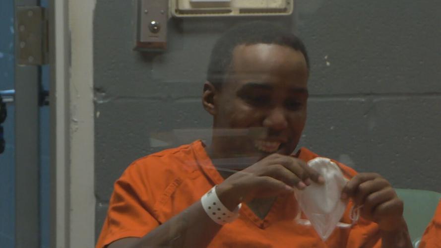 Jemarcus Glover holding mask in Jefferson County court