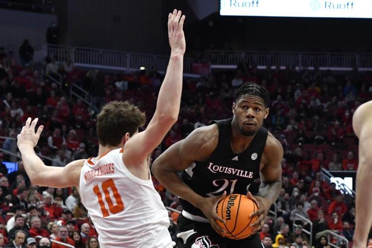 Louisville forward Sydney Curry charges into Clemson forward Ben Middlebrooks.jpeg