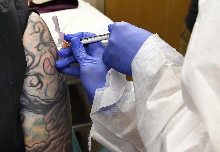 Volunteer gets injection of trial COVID-19 vaccine