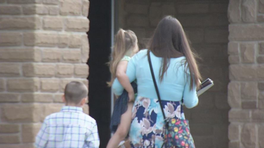 Woman and kids walk into Maryville Baptist Church