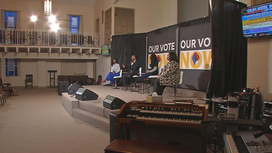 Speakers address a crowd during the "Know the Issues, Own the Vote" Symposium at the Kingdom Fellowship Christian Life Center