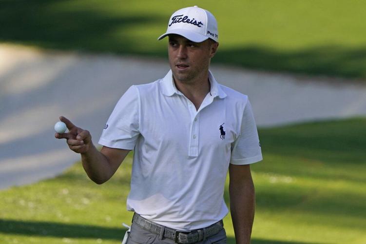 Justin Thomas waves ball after a birdie on the 10th hole during the third round of the Masters golf tournament