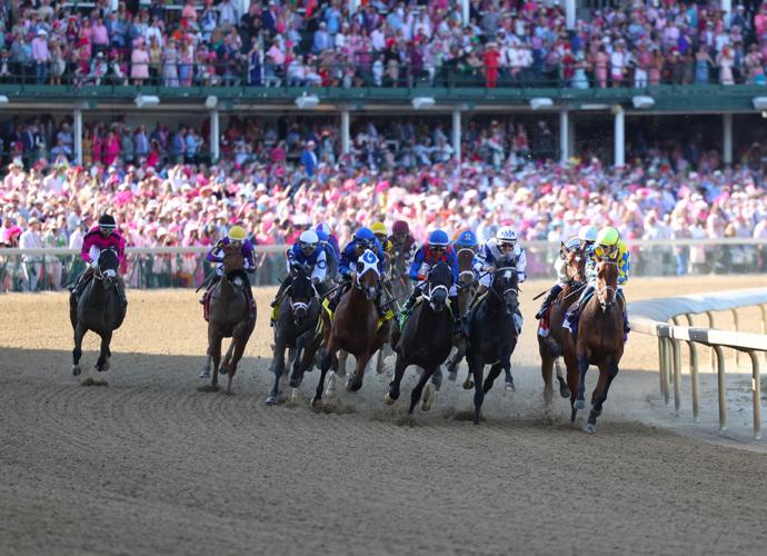Horses pass first turn at Oaks.JPG