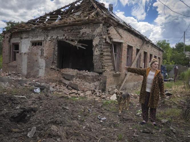 Local resident Tetyana points at her house heavily damaged by the Russian shelling.jpeg