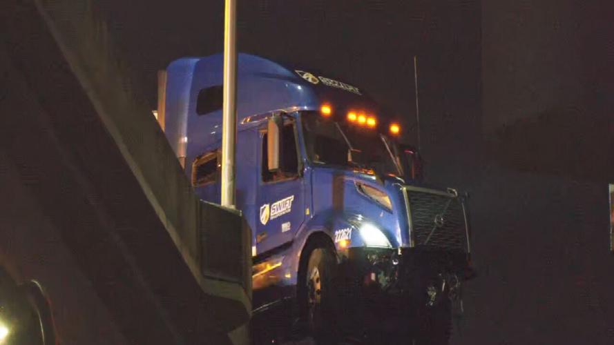 Semi dangles from I-65 ramp after early morning crash