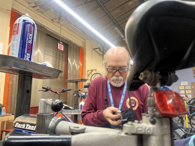 Goodwill Employee fixes bike for Last Mile to Work