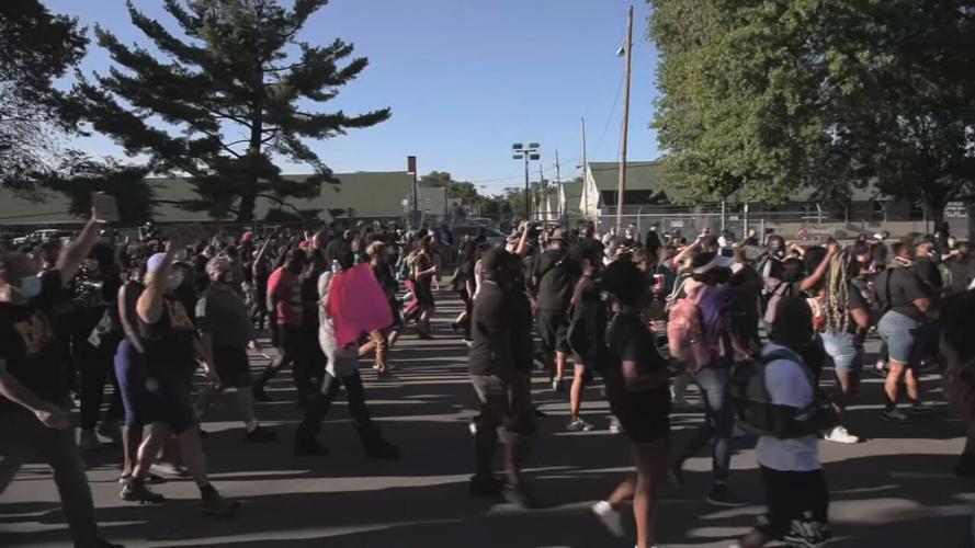 Protesters march past Churchill Downs on Derby day